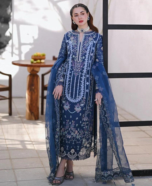 premium unstitched suit featuring a delicately embroidered lawn shirt, paired with a beautifully crafted embroidered organza dupatta and a matching trouser. Designed with elegance and comfort in mind, this outfit is perfect for festive gatherings, semi-formal events, and seasonal wear.